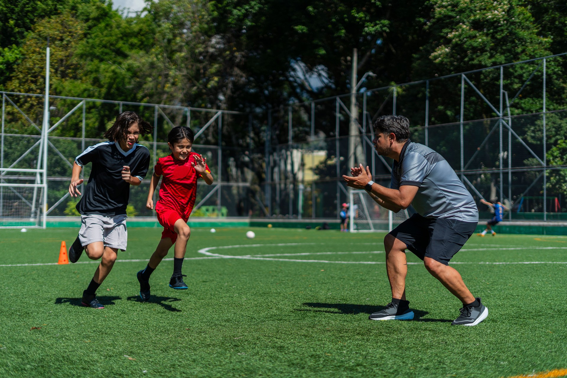 soccer teacher trains children from his sports school